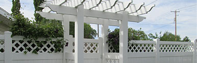 Lattice top style vinyl fence with gated arbor